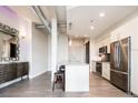 Bright kitchen with stainless steel appliances, granite countertops, and a kitchen island with stools at 3198 Blake St # 502, Denver, CO 80205