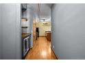 Long hallway boasts wood floors, industrial style lighting, and access to the kitchen at 3299 Lowell Blvd # 204, Denver, CO 80211
