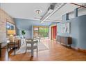 Bright living room with hardwood floors, modern furniture, and a sliding glass door to the outside at 3299 Lowell Blvd # 204, Denver, CO 80211