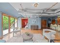 Open-concept living room features hardwood floors, stylish furniture, and access to a bedroom and kitchen at 3299 Lowell Blvd # 204, Denver, CO 80211