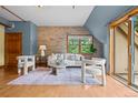 Inviting living room with exposed brick accent wall, lots of natural light, and chic, comfortable furniture at 3299 Lowell Blvd # 204, Denver, CO 80211