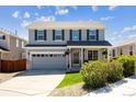 Charming two-story home features a well-manicured lawn, grey siding, and a welcoming front porch at 11866 High Desert Rd, Parker, CO 80134