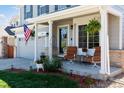 Inviting covered front porch features comfortable seating, plants, and stylish decor at 11866 High Desert Rd, Parker, CO 80134