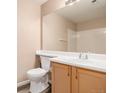 Well-lit bathroom featuring a single vanity and white tile at 8707 E Florida Ave # 709, Denver, CO 80247