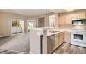 Bright kitchen with stainless appliances and access to balcony at 8707 E Florida Ave # 709, Denver, CO 80247
