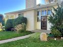Close-up of the white brick home's front door and lush front yard landscaping at 2789 S Ivan Way, Denver, CO 80227