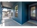 Inviting covered porch with elegant railings and a view of the neighborhood at 5608 Grandville Ave, Longmont, CO 80503