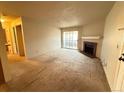 Spacious living room featuring a fireplace and sliding glass door to balcony at 1074 S Dearborn St # 306, Aurora, CO 80012