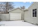 Detached garage with white doors provides ample parking and storage space in this charming residence at 7135 W 24Th Ave, Lakewood, CO 80214