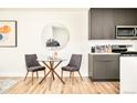 Charming dining area featuring a glass table, modern chairs, and a sleek mirror on the wall at 1168 S Reed Way, Lakewood, CO 80232