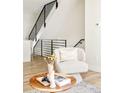 Inviting foyer featuring a cozy chair, stylish table, and a view of the staircase at 1168 S Reed Way, Lakewood, CO 80232