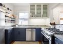 Modern kitchen with navy cabinets, stainless steel appliances, and stylish countertops at 3085 W 36Th Ave, Denver, CO 80211