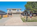 Charming two-story home with a well-maintained lawn, attached garage, and mature trees at 5429 S Waco St, Centennial, CO 80015
