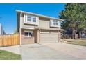 Lovely home featuring brick accents, an attached garage, and a well-manicured front yard at 5429 S Waco St, Centennial, CO 80015