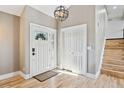 Welcoming foyer with a decorative front door, wood flooring, and a coat closet at 5429 S Waco St, Centennial, CO 80015