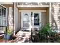 Townhouse exterior with a front door and small garden at 1811 S Quebec Way # 134, Denver, CO 80231