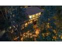 Aerial view of a two-story home surrounded by lush greenery and mature trees at 9506 S Deer Creek Canyon Rd, Littleton, CO 80127