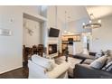 This open-concept living room has high ceilings, a fireplace, and hardwood floors at 5420 Allison St # 202, Arvada, CO 80002