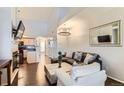 Open-concept living room features soaring ceilings, sleek hardwood floors and stylish lighting at 5420 Allison St # 202, Arvada, CO 80002