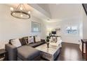 This modern living room has hardwood floors, high ceilings, and comfortable seating at 5420 Allison St # 202, Arvada, CO 80002