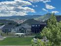 Beautiful community with mountain views, lush greenery and a vibrant blue sky filled with fluffy white clouds at 9804 N Crystal Lake Dr, Littleton, CO 80125