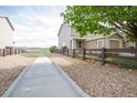 Attractive single-Gathering home with a gravel yard, wooden fence, and an attached single-car garage at 2296 E 109Th Dr, Northglenn, CO 80233