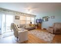Bright living room featuring hardwood floors, neutral paint, lots of natural light, and a sliding door to a patio at 2296 E 109Th Dr, Northglenn, CO 80233
