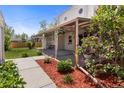Inviting covered back patio with wrought iron posts and flowering plants at 1400 S Knox Ct, Denver, CO 80219