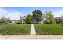 Charming home with a manicured lawn and mature trees at 1400 S Knox Ct, Denver, CO 80219