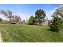 Well-maintained home with a spacious front yard and mature landscaping at 1400 S Knox Ct, Denver, CO 80219
