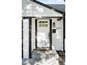 Inviting entryway featuring a white door with grid window and a black door frame at 2430 Eaton St, Edgewater, CO 80214