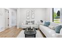 Bright living room featuring light colored walls, hardwood floors, and modern furniture at 2430 Eaton St, Edgewater, CO 80214