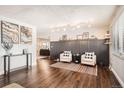 Living room featuring hardwood floors, two armchairs, and a fireplace at 4481 W 89Th Way, Westminster, CO 80031