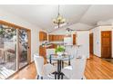 Cozy dining area with hardwood floors, sliding glass doors to the deck, and stylish lighting at 837 Meadow Run, Golden, CO 80403