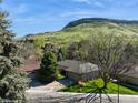 Aerial view of single Gathering home showcasing mature landscaping and mountain views at 837 Meadow Run, Golden, CO 80403