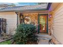 Charming front entrance with stone accents, a unique window, and a welcoming doorway at 837 Meadow Run, Golden, CO 80403