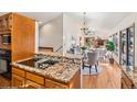 Bright living area features a fireplace, hardwood floors, and kitchen with granite countertops at 837 Meadow Run, Golden, CO 80403