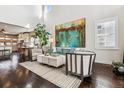 Bright living room featuring high ceilings, modern decor, and hardwood floors at 8461 E 54Th Dr, Denver, CO 80238