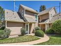 Exterior of townhomes with neutral siding, well-kept lawns, and inviting entrances at 13598 E Asbury Dr, Aurora, CO 80014