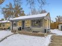 Charming ranch home with snowy front yard and cozy porch at 424 S Leyden St, Denver, CO 80224