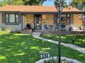 Charming home exterior with inviting front porch, walkway and manicured green lawn at 424 S Leyden St, Denver, CO 80224