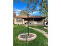 Charming home boasts a well-manicured lawn, brick accents, and a welcoming walkway at 424 S Leyden St, Denver, CO 80224