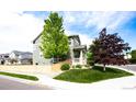 Corner lot home with a wood fence, mature trees, and a cozy covered porch at 5550 Fox Meadow Ave, Highlands Ranch, CO 80130
