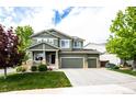 Charming two-story home with a three-car garage and an inviting covered porch at 5550 Fox Meadow Ave, Highlands Ranch, CO 80130