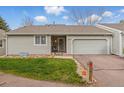 Charming single Gathering home featuring an attached garage and a well-manicured front lawn at 2838 S Heather Gardens Way # A, Aurora, CO 80014