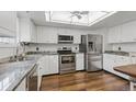 Modern kitchen featuring white cabinets, stainless steel appliances, and granite countertops at 2838 S Heather Gardens Way # A, Aurora, CO 80014