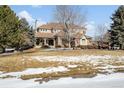 Two story house with stone accents and a large front yard at 7285 Sagebrush Dr, Parker, CO 80138