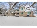 Snowy exterior shot showcases the townhome's architecture and winter landscape at 1129 W 112Th Ave # C, Denver, CO 80234