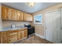 Functional kitchen features wood cabinets, stainless steel appliances, and a window at 1200 Newark St, Aurora, CO 80010
