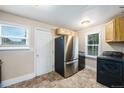 Kitchen with stainless steel refrigerator and modern washer/dryer at 1200 Newark St, Aurora, CO 80010